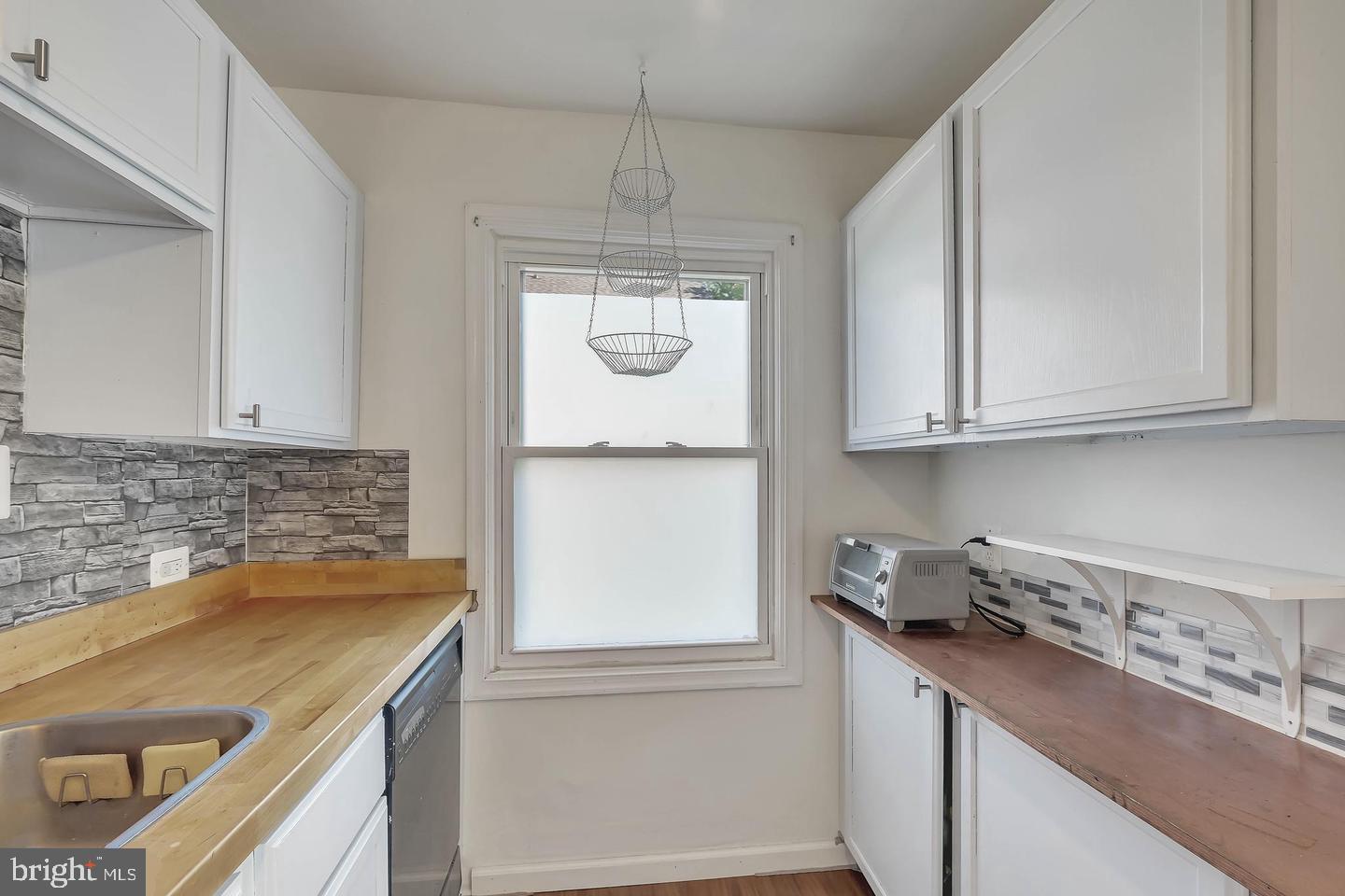 11 Hillside Road Greenbelt, MD 20770 - Photo 20 of 47 a kitchen with a sink and cabinets