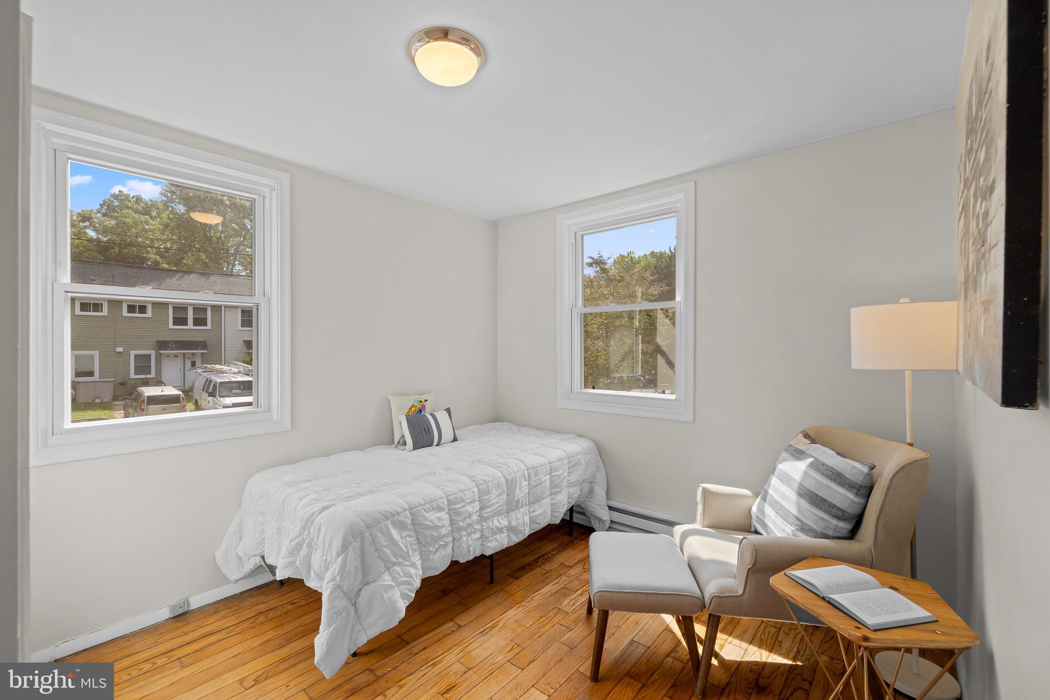 11 Hillside Road Greenbelt, MD 20770 - Photo 21 of 47 a bedroom with a bed and wooden floor