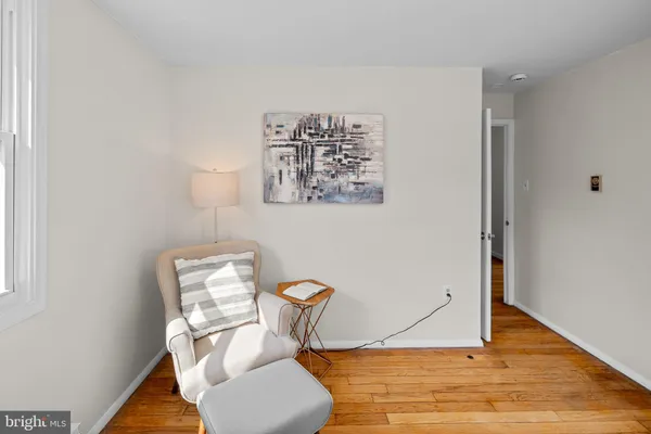 a view of a workspace with furniture and wooden floor