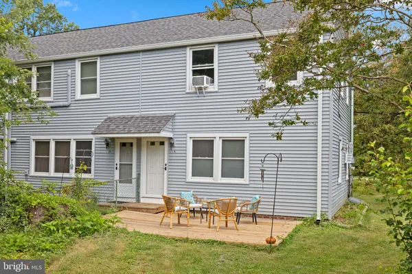 a backyard of a house with table and chairs