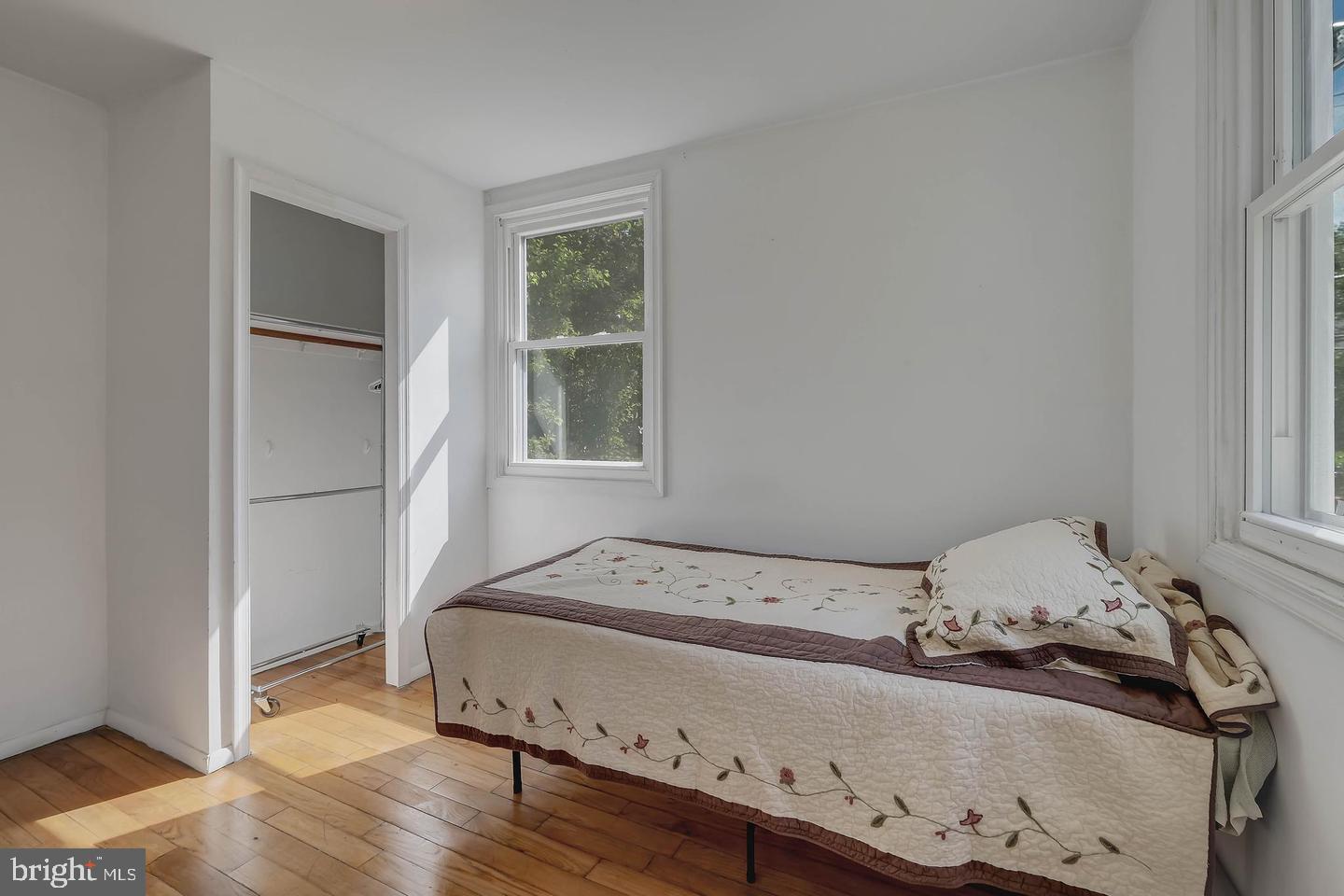 11 Hillside Road Greenbelt, MD 20770 - Photo 38 of 47 a bedroom with a bed and wooden floor