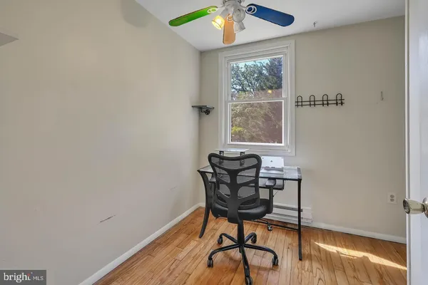 a workspace room with furniture and wooden floor