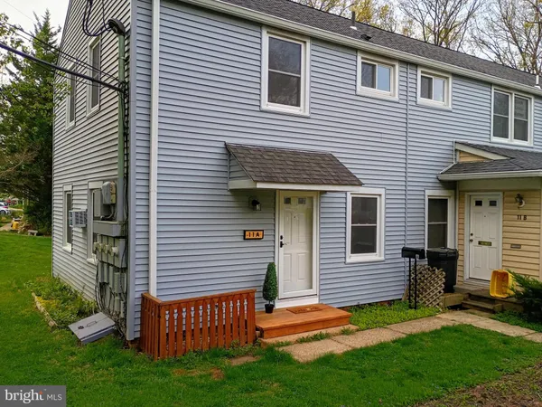 a view of a house with a yard and sitting area
