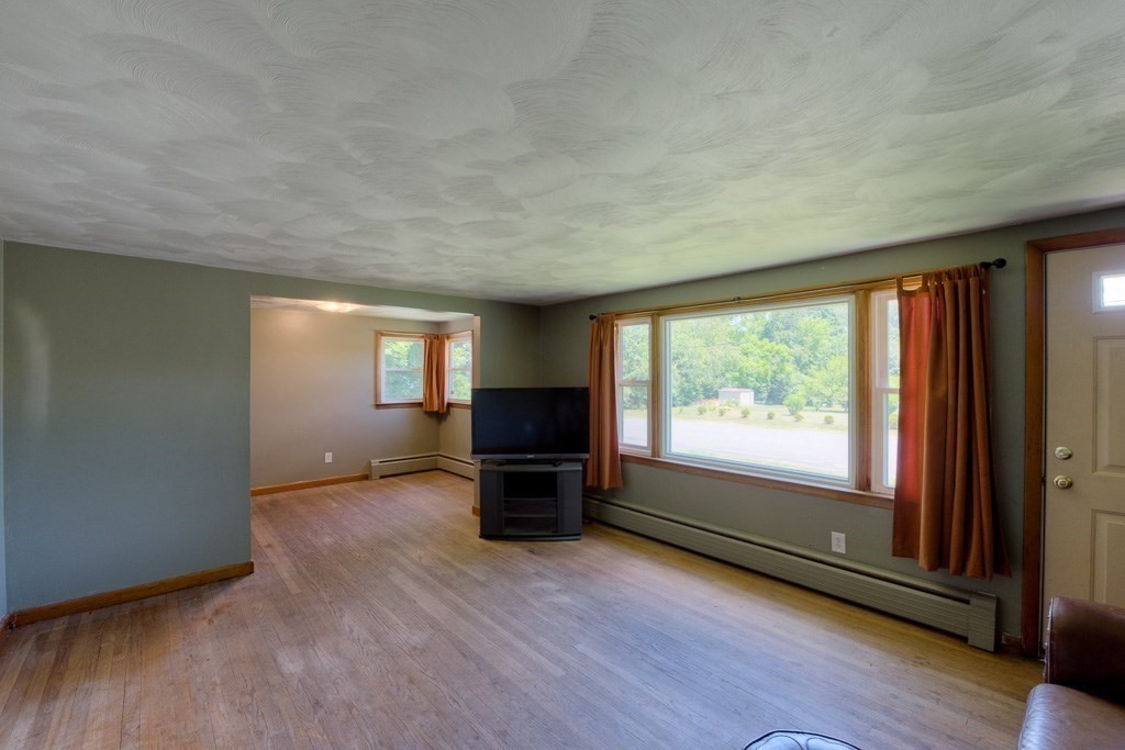 24 Edgewood Street Three Rivers, MA 01080 - Photo 11 of 37 an empty room with wooden floor and a window