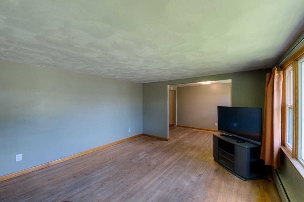 24 Edgewood Street Three Rivers, MA 01080 - Photo 12 of 37 a view of room with wooden floor and flat screen tv