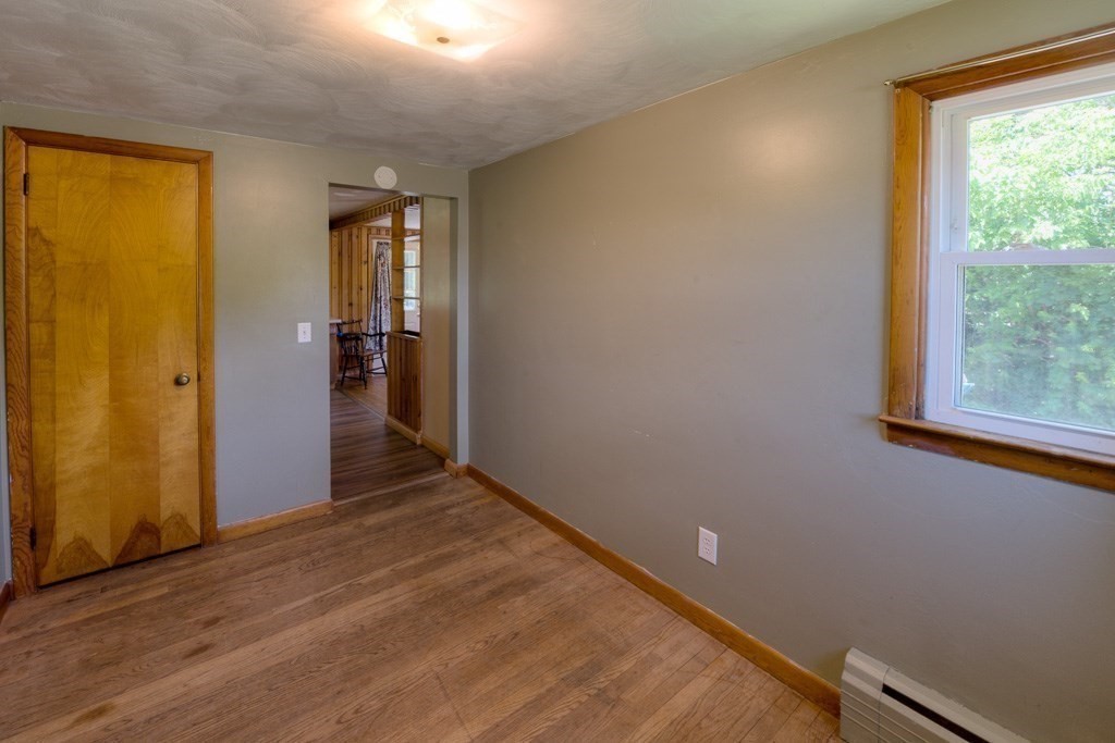 24 Edgewood Street Three Rivers, MA 01080 - Photo 14 of 37 an empty room with wooden floor and windows