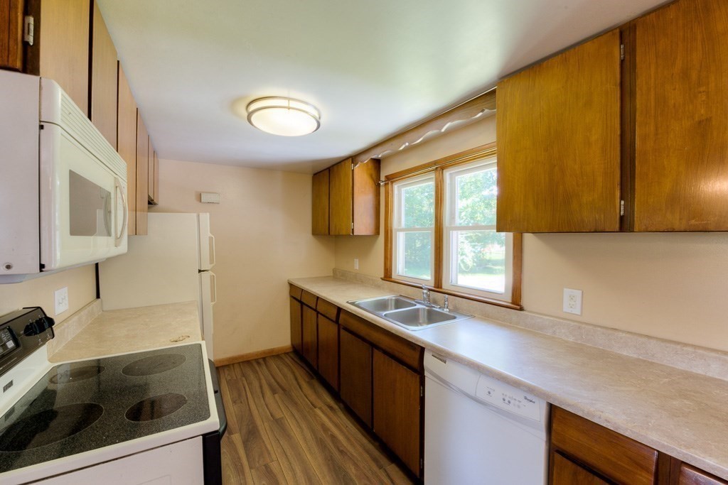 24 Edgewood Street Three Rivers, MA 01080 - Photo 16 of 37 a kitchen that has a sink a stove and wooden cabinets