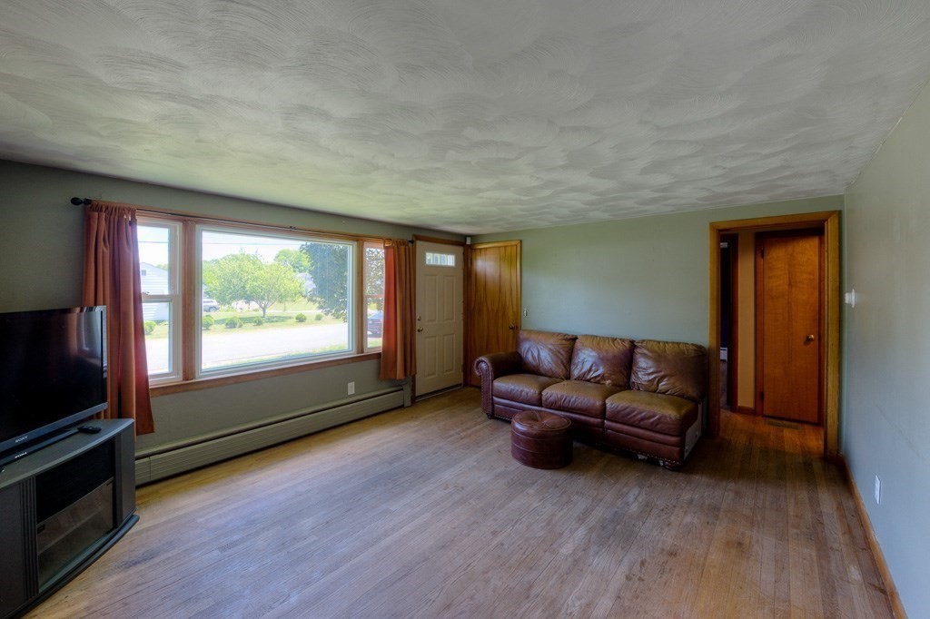 24 Edgewood Street Three Rivers, MA 01080 - Photo 4 of 37 a living room with furniture and a flat screen tv