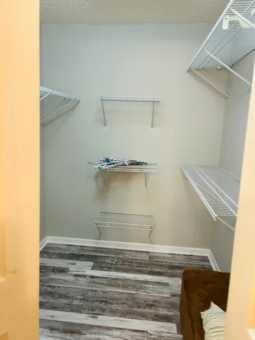 a bedroom with a bed and a dresser next to a window