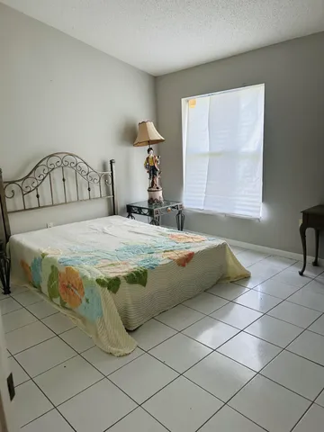 a front view of multi story residential apartment building with garage and parking area