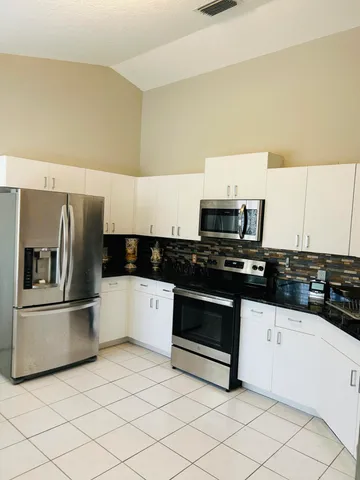 a dining room with furniture and a window