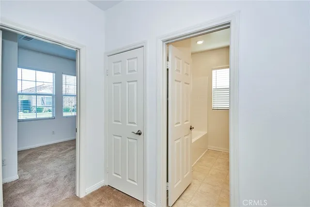 a view of a bathroom from a hallway