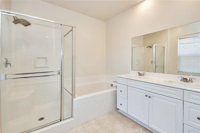 a bathroom with a granite countertop sink a mirror a shower and a bathtub