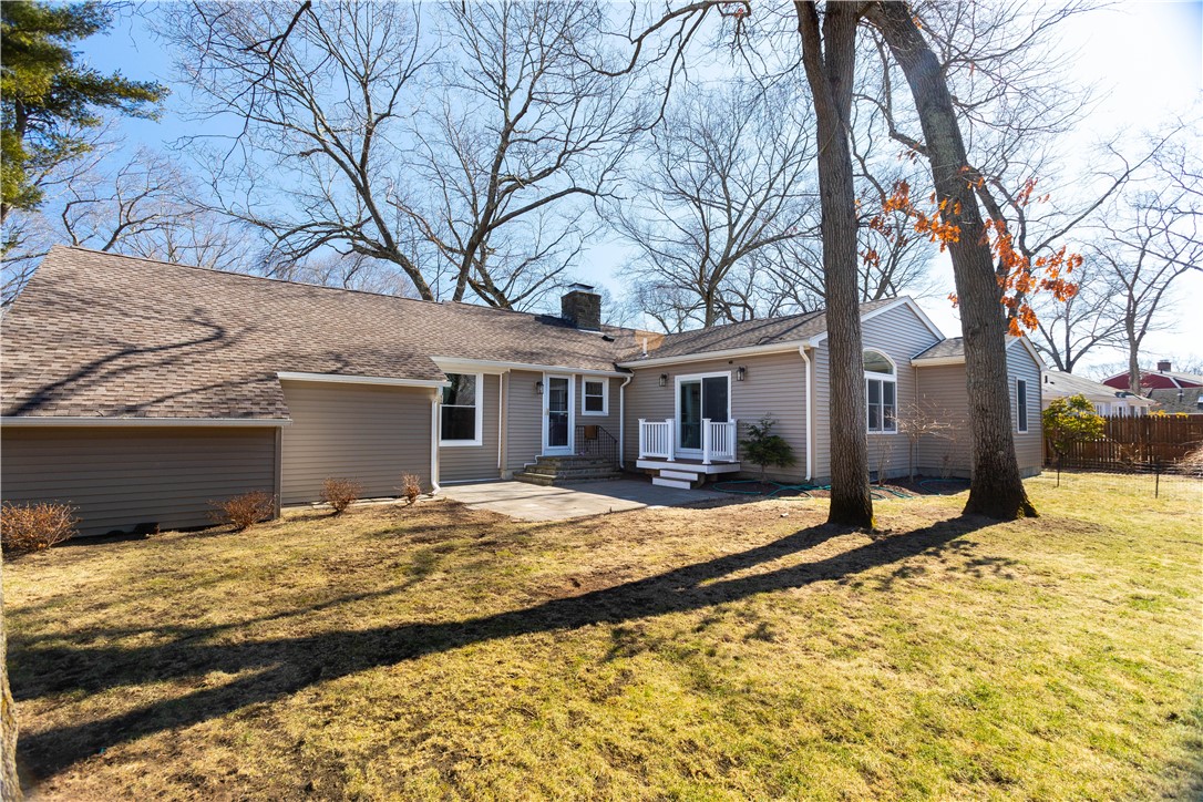 19 Silver Birch Road Warwick, RI 02888 - Photo 33 of 37 Treed, Flat Backyard with patio, slider to Great Room, separate entrance to Kitchen.