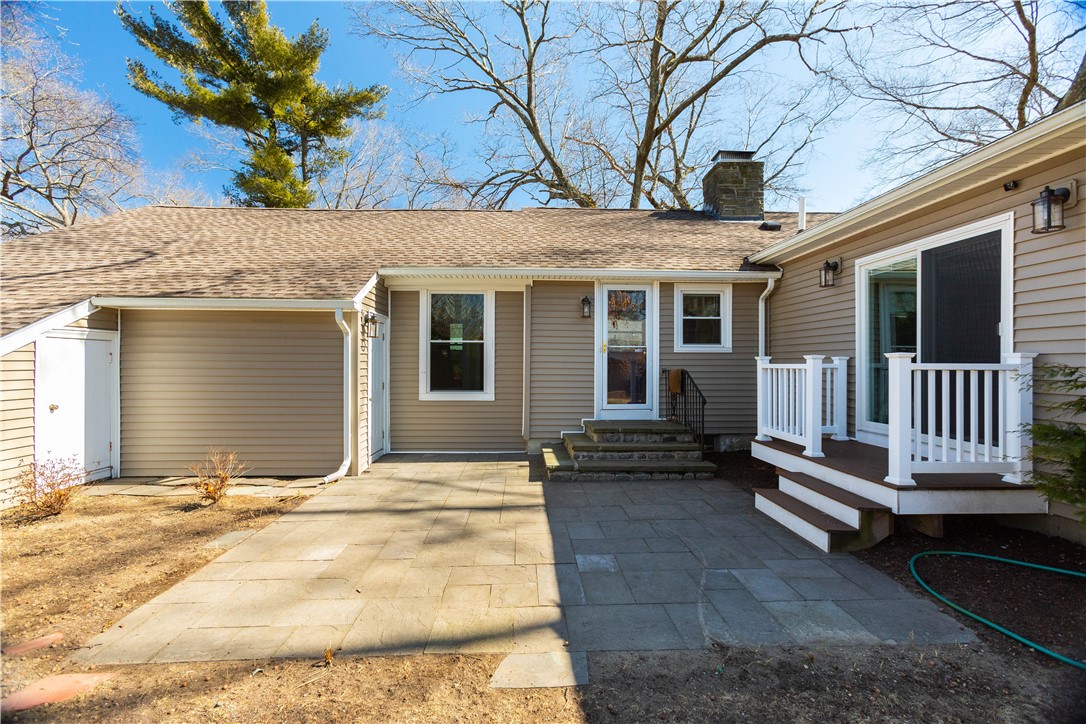 19 Silver Birch Road Warwick, RI 02888 - Photo 34 of 37 Backyard. Entrance to Kitchen, garage, deck with sliders to Great Room.