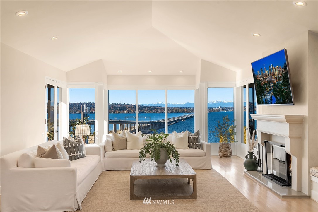 3223 Evergreen Point Road Medina, WA 98039 - Photo 12 of 36 a living room with furniture a fireplace and a flat screen tv