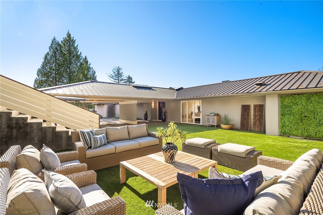 3223 Evergreen Point Road Medina, WA 98039 - Photo 31 of 36 a view of a house with couches chairs and a yard