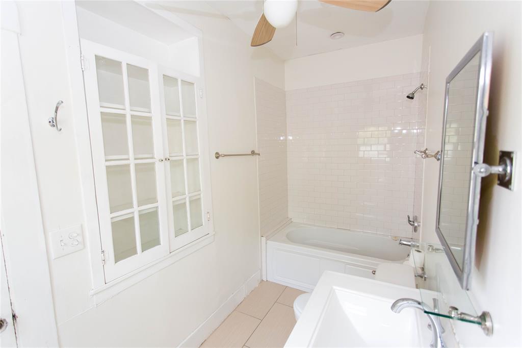 201 West 33rd Street, Unit A Austin, TX 78705 - Photo 12 of 20 a bathroom with a bathtub and a shower