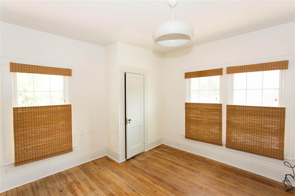 201 West 33rd Street, Unit A Austin, TX 78705 - Photo 17 of 20 an empty room with wooden floor and windows