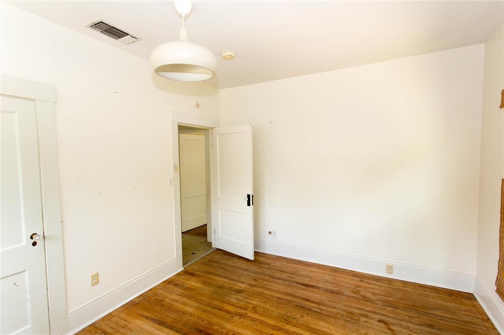 201 West 33rd Street, Unit A Austin, TX 78705 - Photo 18 of 20 a view of a room with wooden floor and a ceiling fan