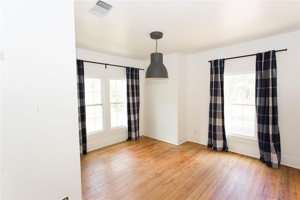 201 West 33rd Street, Unit A Austin, TX 78705 - Photo 19 of 20 an empty room with wooden floor and windows