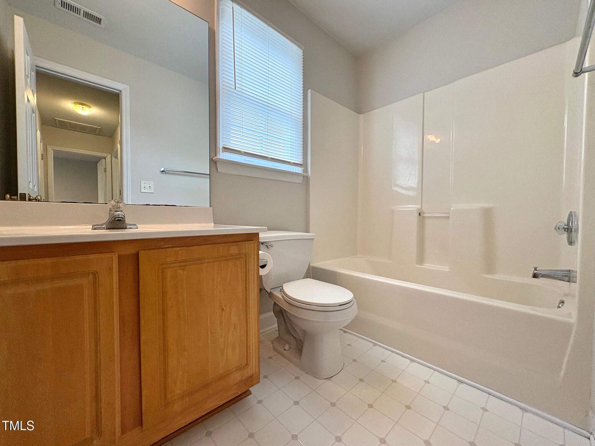 111 Gumdrop Path Apex, NC 27502 - Photo 13 of 17 a bathroom with a sink toilet and shower