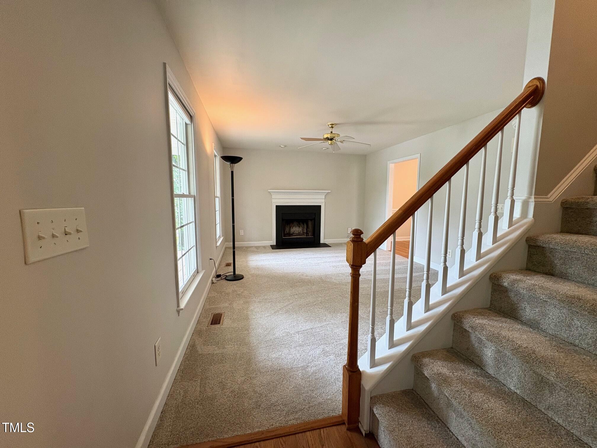 111 Gumdrop Path Apex, NC 27502 - Photo 3 of 17 a view of staircase with lots of frames on wall and a window