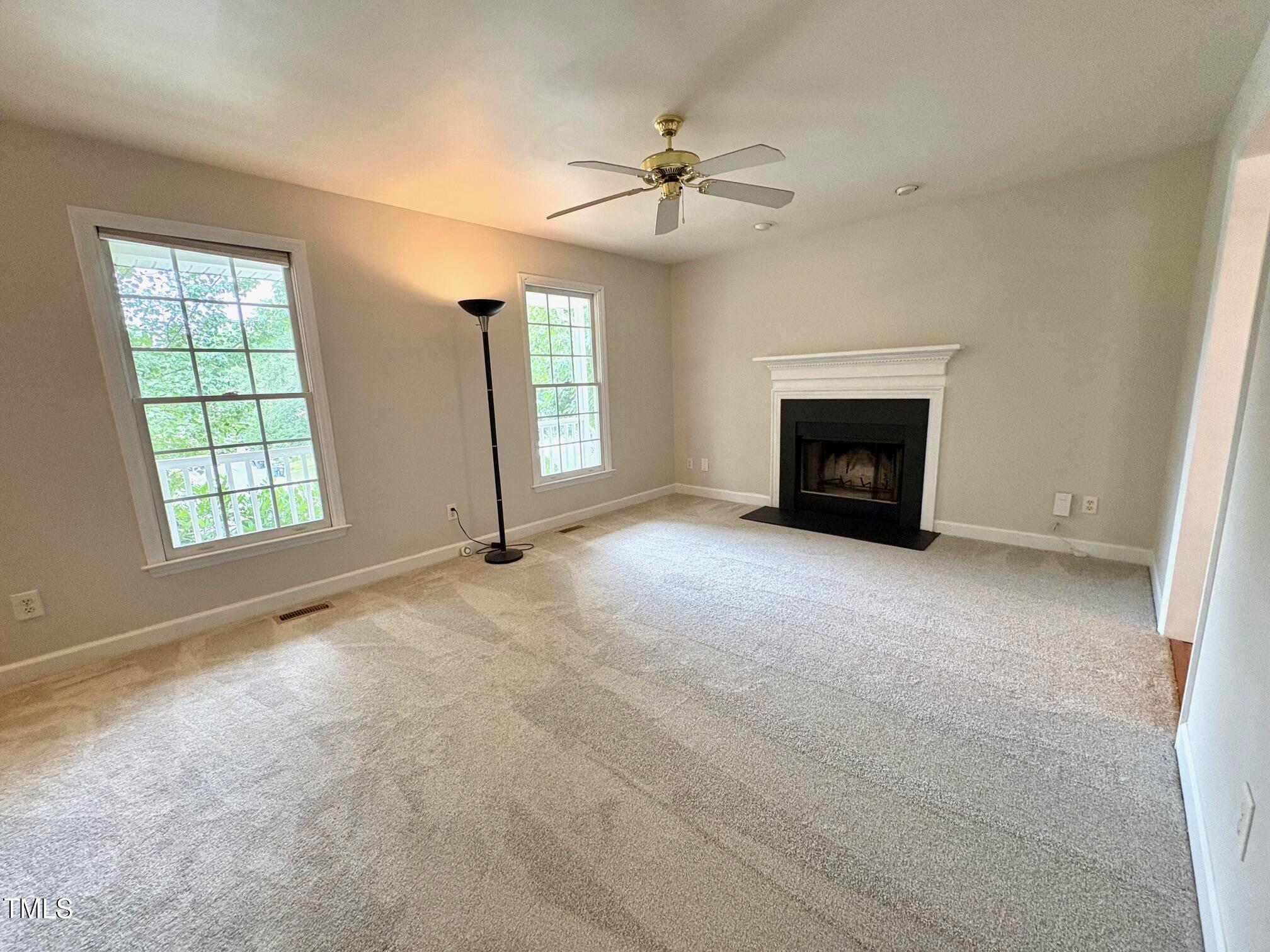 111 Gumdrop Path Apex, NC 27502 - Photo 4 of 17 an empty room with windows and fireplace