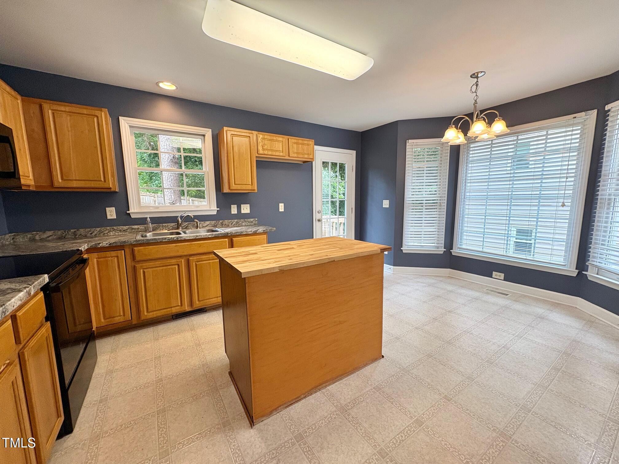 111 Gumdrop Path Apex, NC 27502 - Photo 6 of 17 a view of a kitchen with granite countertop a sink and a refrigerator