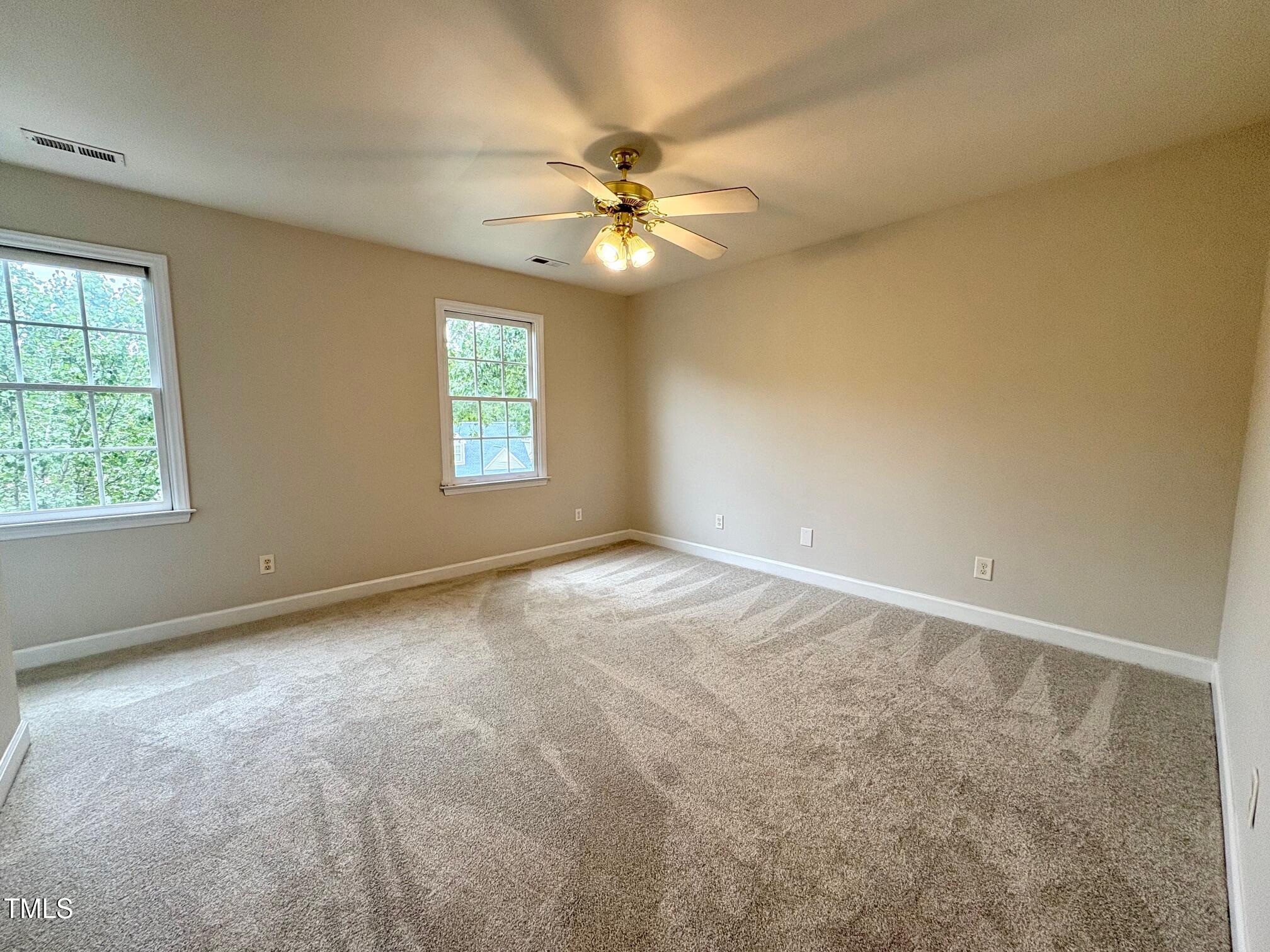 111 Gumdrop Path Apex, NC 27502 - Photo 9 of 17 an empty room with a window and a fan