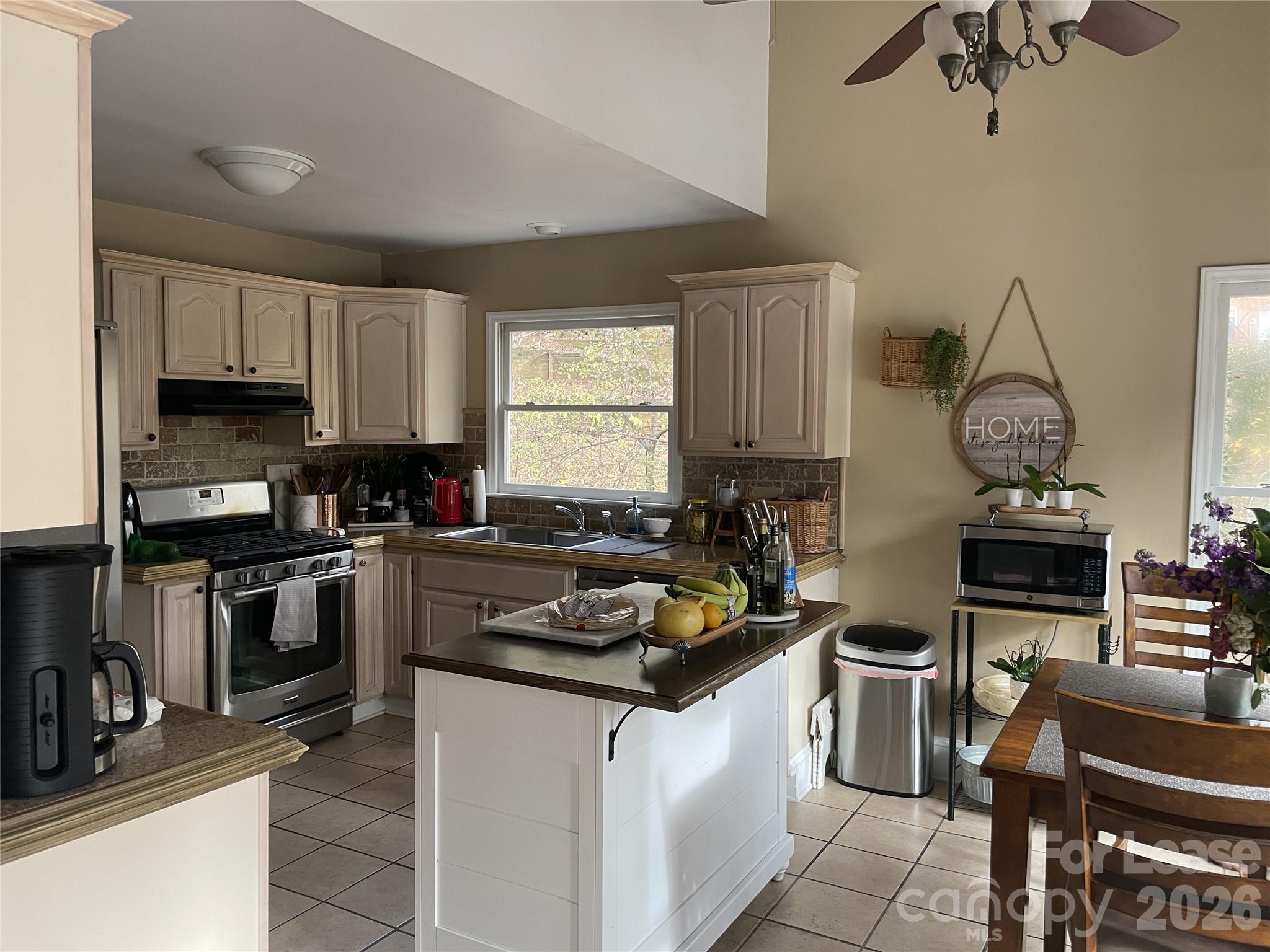 3800 Oldfield Road Charlotte, NC 28226 - Photo 6 of 32 a kitchen with stainless steel appliances a stove a sink a microwave and cabinets