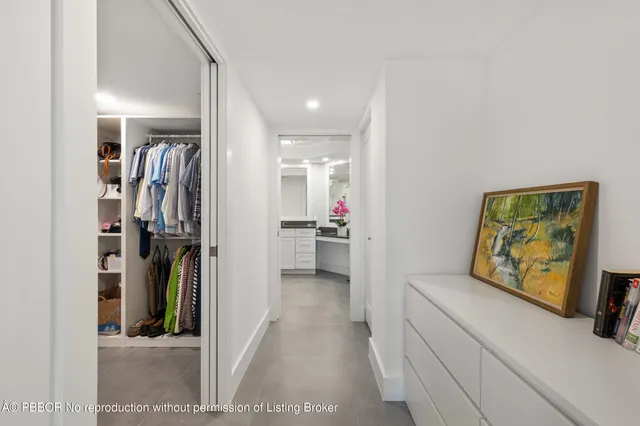 a view of a hallway with closet and a window