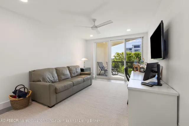 a living room with furniture a flat screen tv and a large window