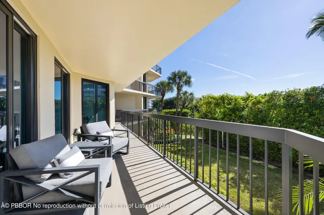 a balcony with wooden floor and outdoor seating