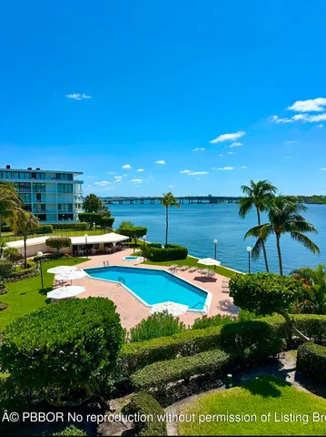 a view of a swimming pool with a yard