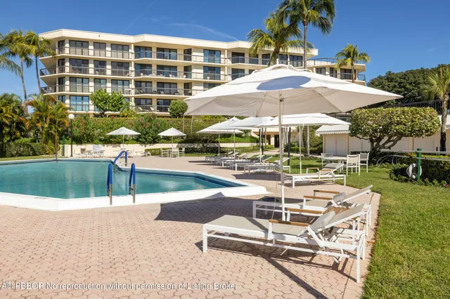 a view of a building with garden and sitting area