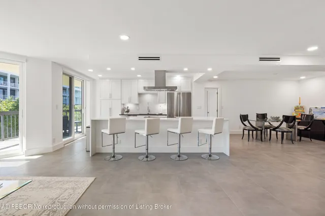 a living room with chairs and a table