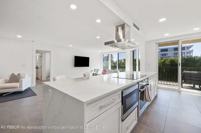 a large white kitchen with a large window