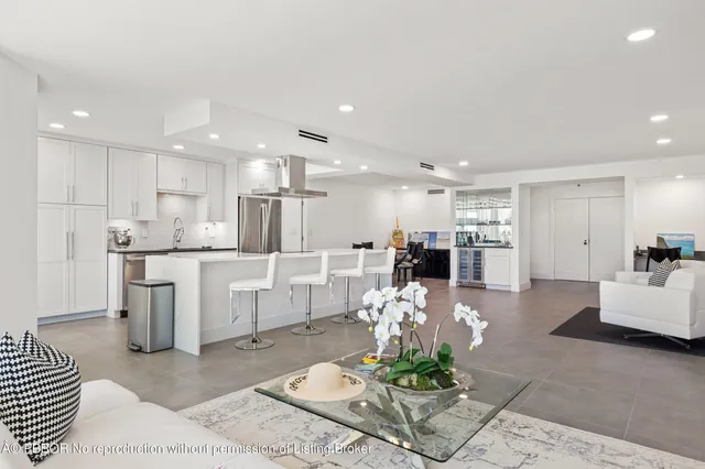 a living room with furniture and kitchen view