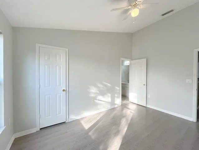 a bathroom with a granite countertop sink a toilet and a mirror