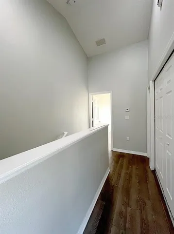 a view of a room with wooden floor and cabinet