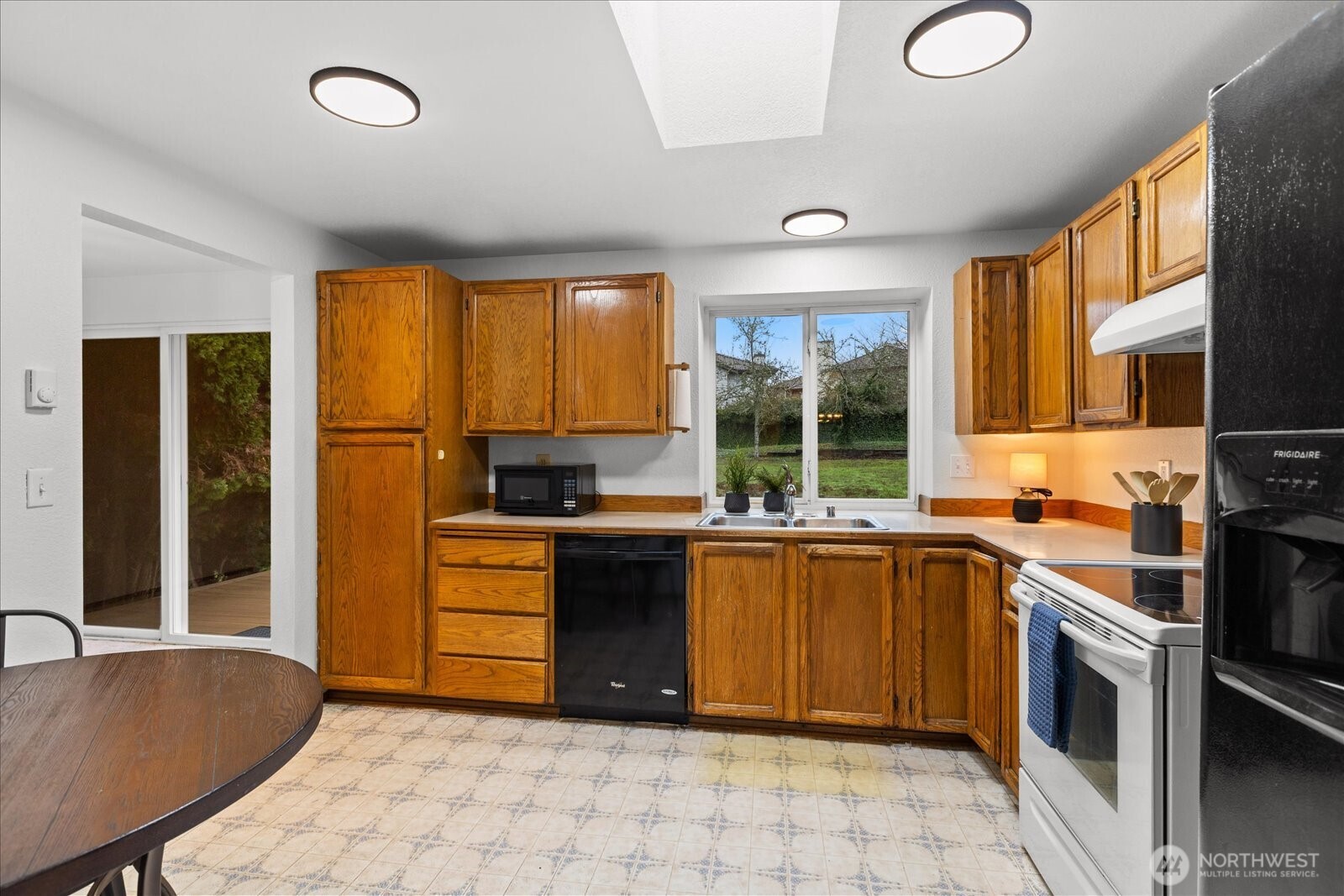1403 234th Street Southwest Bothell, WA 98021 - Photo 12 of 37 a kitchen with a stove a sink and a refrigerator