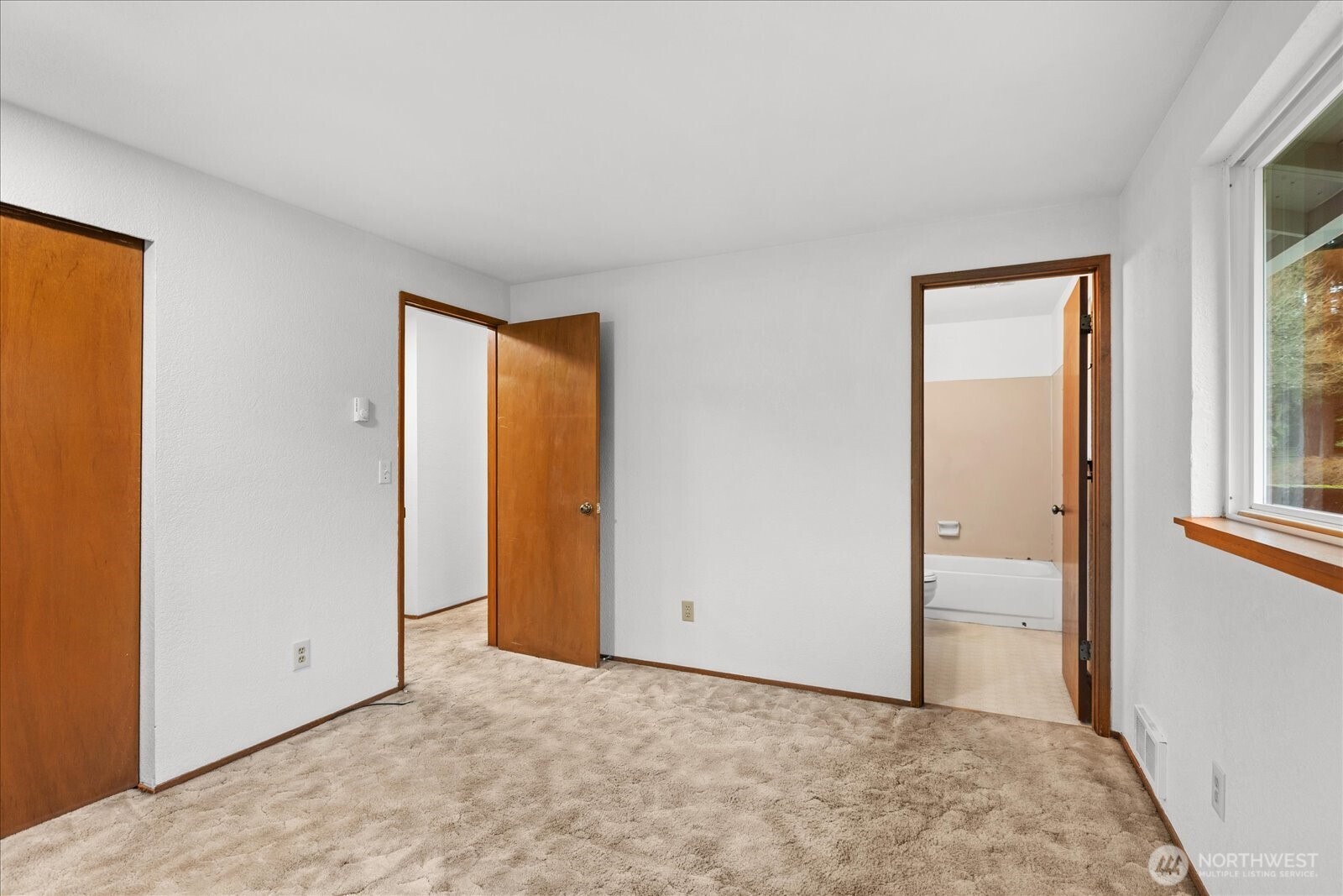 1403 234th Street Southwest Bothell, WA 98021 - Photo 15 of 37 a view of an empty room with closet and a window