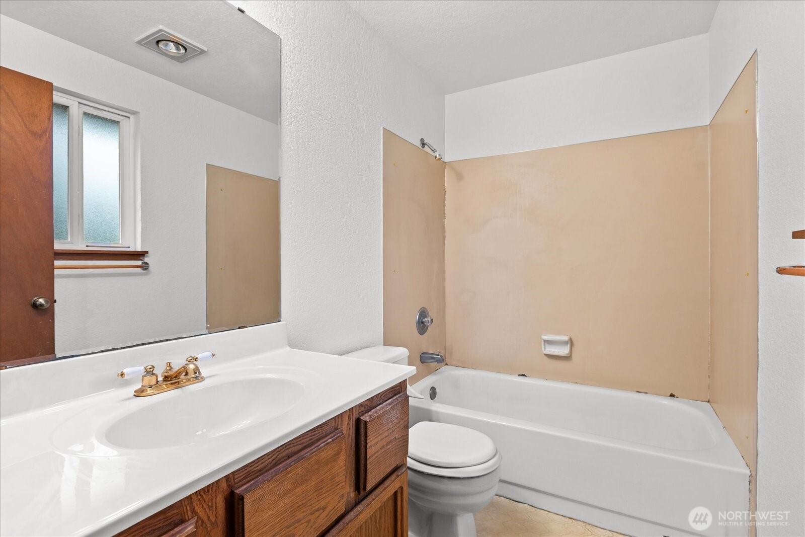 1403 234th Street Southwest Bothell, WA 98021 - Photo 16 of 37 a bathroom with a sink a toilet and a bathtub