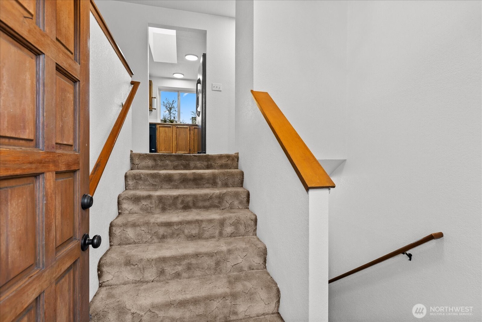 1403 234th Street Southwest Bothell, WA 98021 - Photo 20 of 37 a view of staircase with white walls and black door