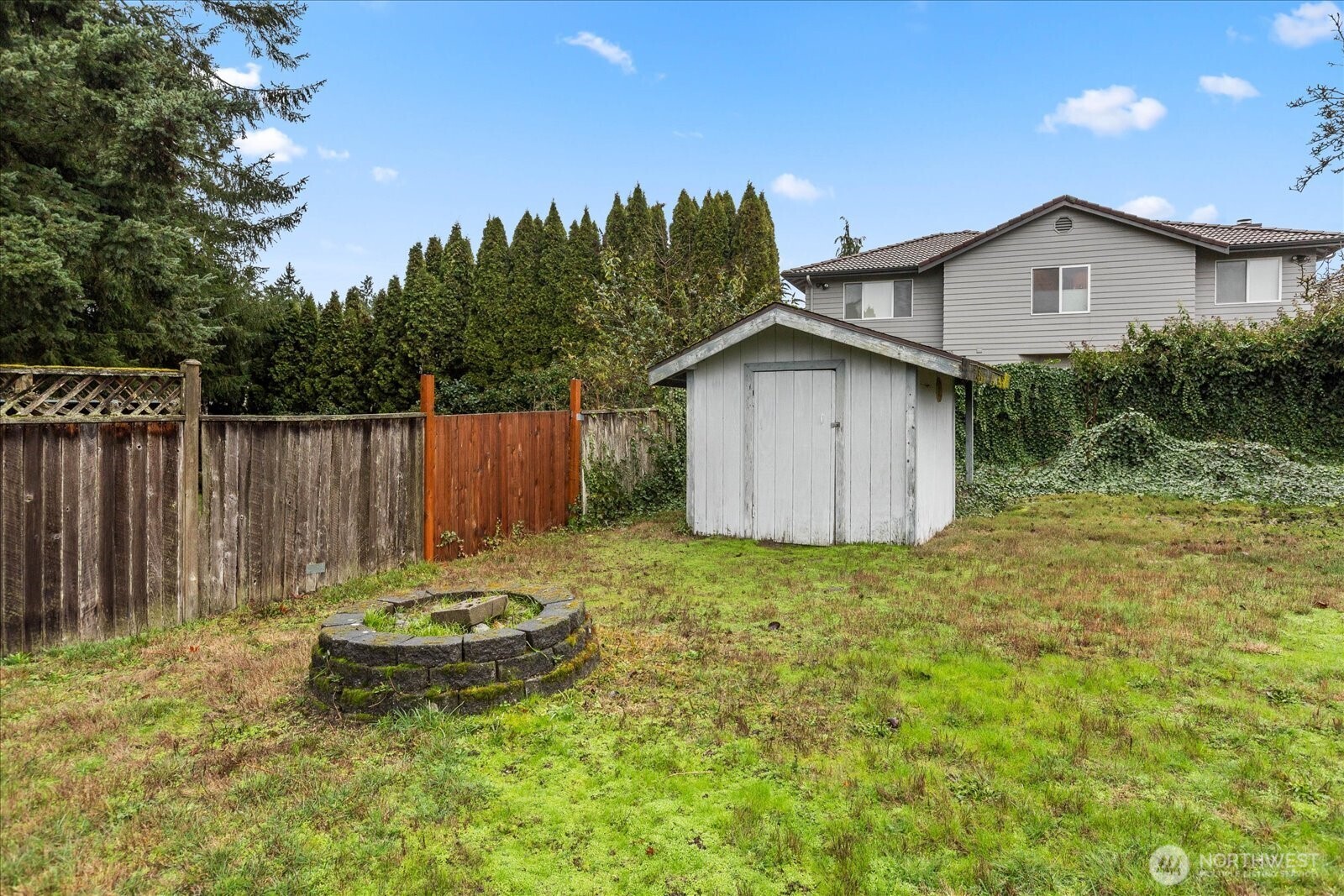 1403 234th Street Southwest Bothell, WA 98021 - Photo 30 of 37 a view of a backyard with table and chairs and wooden fence