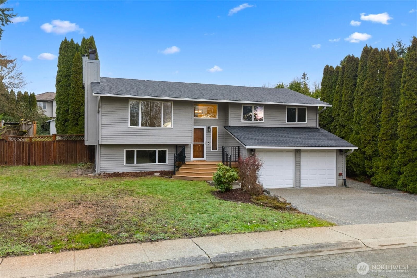 1403 234th Street Southwest Bothell, WA 98021 - Photo 35 of 37 a front view of a house with a yard and garage