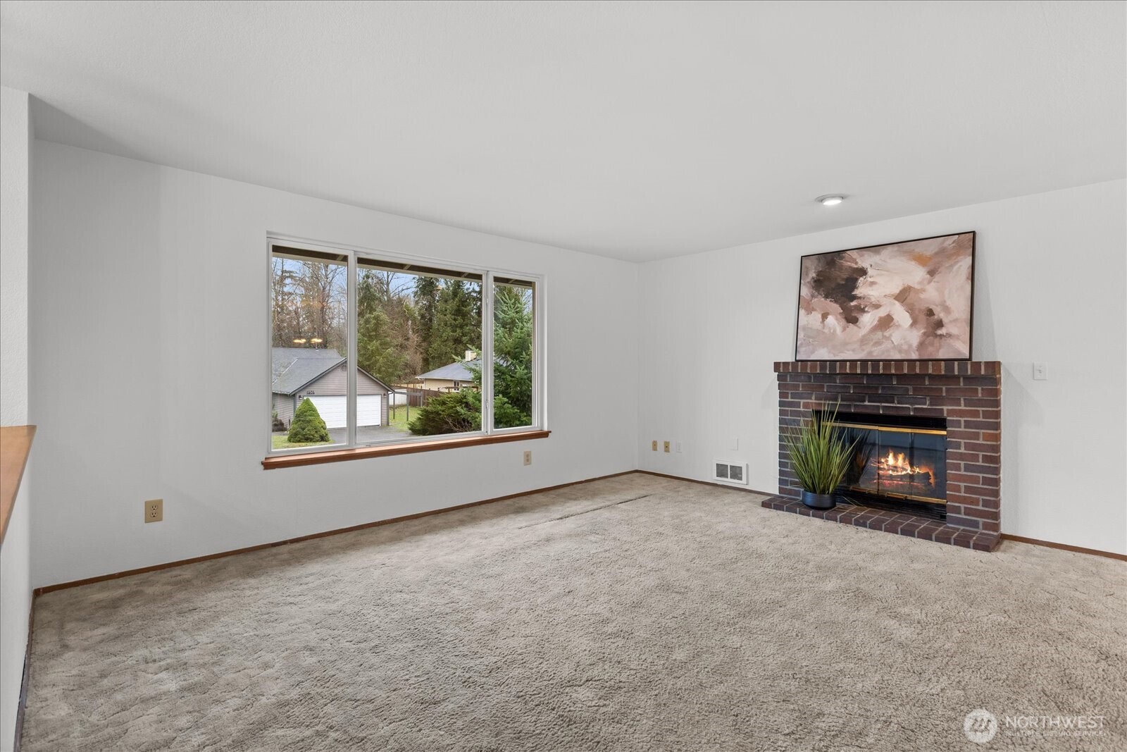 1403 234th Street Southwest Bothell, WA 98021 - Photo 4 of 37 a view of an empty room with a fireplace and a window