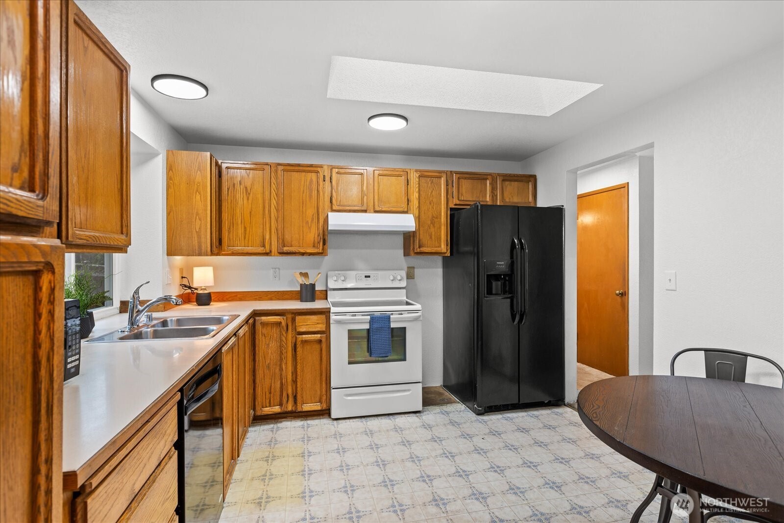 1403 234th Street Southwest Bothell, WA 98021 - Photo 10 of 37 a kitchen with stainless steel appliances granite countertop a refrigerator a sink a stove and island