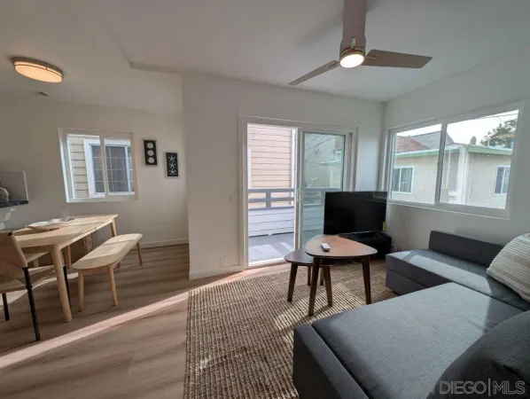 a work room with furniture wooden floor and a window